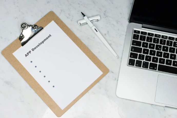 white printer paper beside silver key